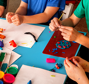 Students working with crafts at a classroom table